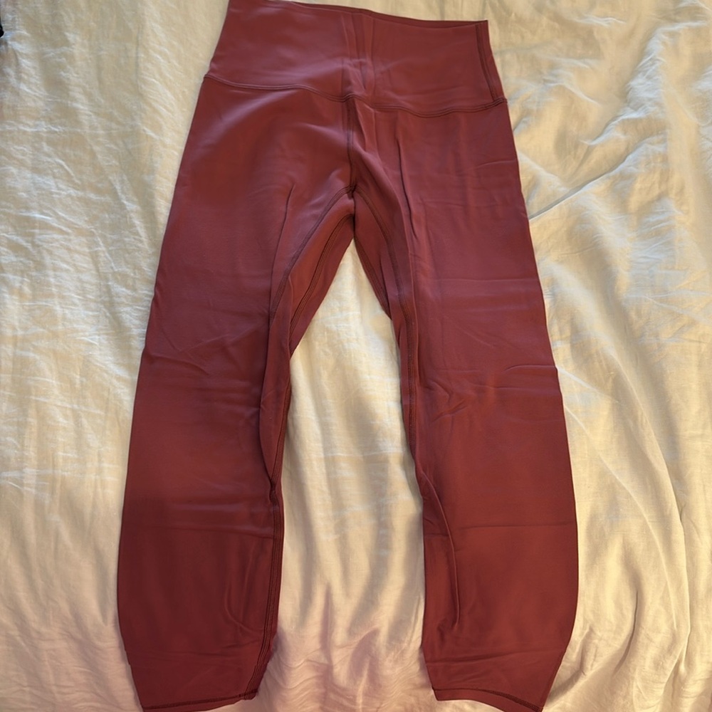 Lululemon. Size 6. Mauve / Red color leggings. 25 inch.l